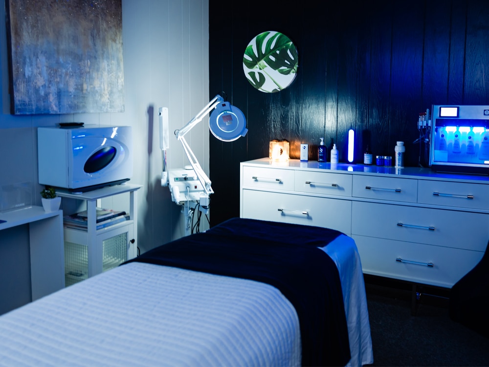 a bedroom with a bed and desk in a room
